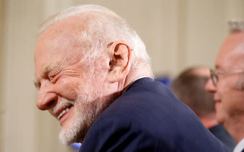 Former astronaut Buzz Aldrin laughs at a joke told by U.S. President Donald Trump - Credit: Reuters