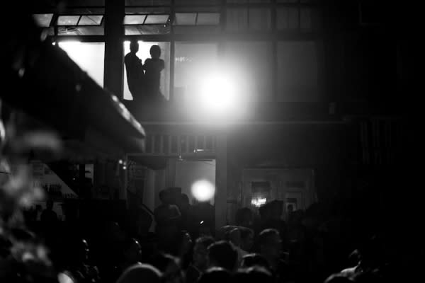 Two shadows above Escobar in Cubao X watch the action from the second floor.