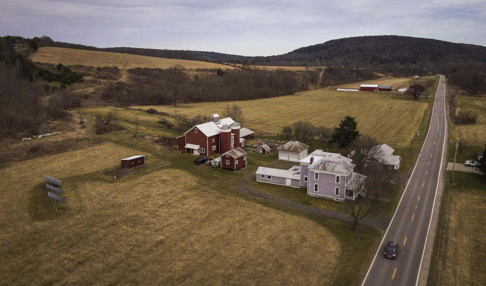 A car passes the Itaska Valley Farm, owned by Joan and Harold Koster, Wednesday, March 13, 2024, in Whitney Point, N.Y. The Kosters were asked by Texas-based Southern Tier Energy Solutions to lease their land to extract natural gas by injecting carbon dioxide into the ground, which they rejected and are opposed to. (AP Photo/Heather Ainsworth)