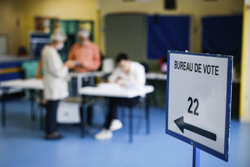 A voter casts his ballot in a voting station Sunday, June 19, 2022 in Neuilly-our-Seine, outside Paris. French voters are going to the polls in the final round of key parliamentary elections that will demonstrate how much legroom President Emmanuel Macron's party will be given to implement his ambitious domestic agenda. (AP Photo/Thomas Padilla)