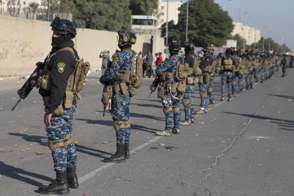 Iraqi security forces are deployed in front of the U.S. embassy, in Baghdad, Iraq, Wednesday, Jan. 1, 2020. Iran-backed militiamen have withdrawn from the U.S. Embassy compound in Baghdad after two days of clashes with American security forces. (AP Photo/Nasser Nasser)