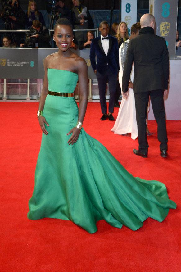 Kenyan actress Lupita Nyong'o poses for photographers on the red carpet at the EE British Academy Film Awards held at the Royal Opera House on Sunday Feb. 16, 2014, in London. (photos by Jon Furniss/Invision/AP)