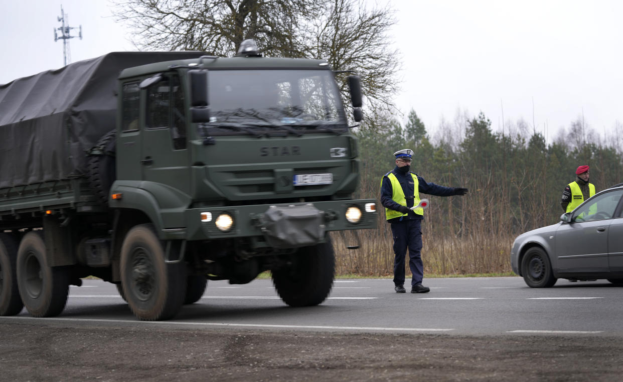 A polish army vehicle drives past a check point close to the border with Belarus in Kuznica, Poland, Tuesday, Nov. 16, 2021. (AP Photo/Matthias Schrader)
