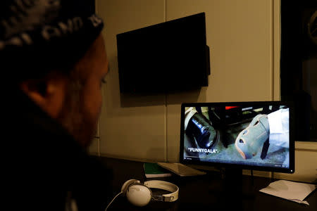 A man looks at a computer screen displaying, what they say is a satire video clip on a social media site, in Islamabad, Pakistan March 14, 2019. Picture taken March 14, 2019. REUTERS/Akhtar Soomro