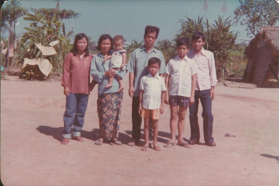 Heang Uy (the baby in the photo) is held by his mother in this family photo taken in 1979 in Thailand.