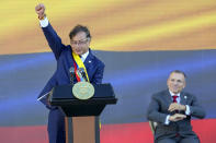 President Gustavo Petro raises his fist at the end of his inauguration speech in Bogota, Colombia, Sunday, Aug. 7, 2022. (AP Photo/Fernando Vergara)