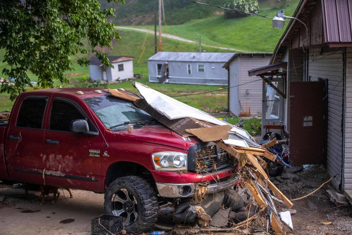 A truck and buildings damaged by flash flooding from Troublesome Creek sit along KY 550 near Dwarf, Ky., on Thursday, Aug. 4, 2022.