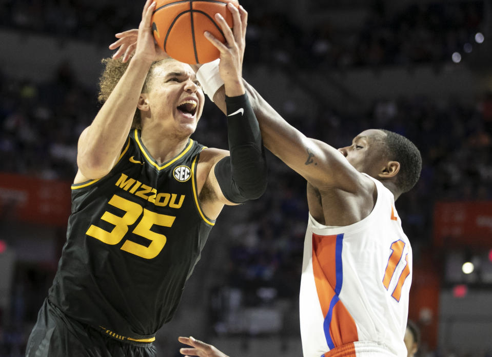 Missouri forward Noah Carter (35) drives against Florida guard Kyle Lofton (11) during the first half of an NCAA college basketball game Saturday, Jan. 14, 2023, in Gainesville, Fla. (AP Photo/Alan Youngblood)