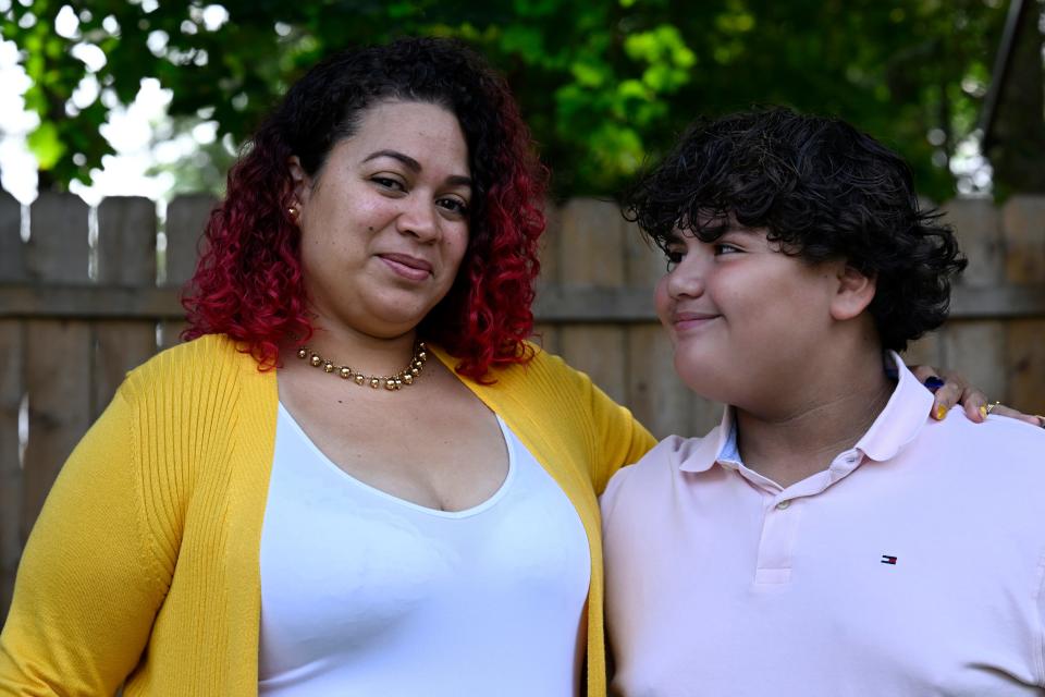 Rousmery Negrón stands with her son at home in Springfield, Mass., on Thursday, Aug. 3, 2023.