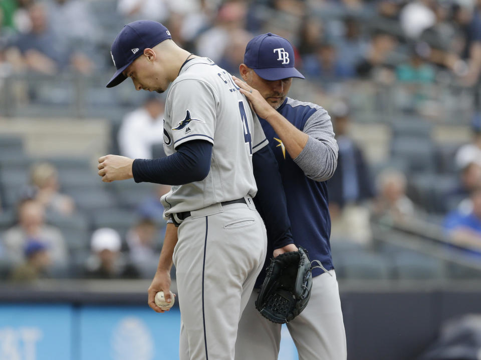 Tampa Bay Rays manager Kevin Cash, right, pulls starting pitcher Blake Snell from the game during the first inning of a baseball game against the New York Yankees at Yankee Stadium, Wednesday, June 19, 2019, in New York. (AP Photo/Seth Wenig)