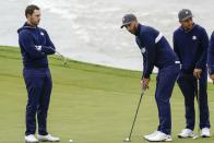 Team USA's Dustin Johnson, Team Europe's Paul Casey and Team USA's Xander Schauffele putt on the third hole during a practice day at the Ryder Cup at the Whistling Straits Golf Course Tuesday, Sept. 21, 2021, in Sheboygan, Wis. (AP Photo/Ashley Landis)