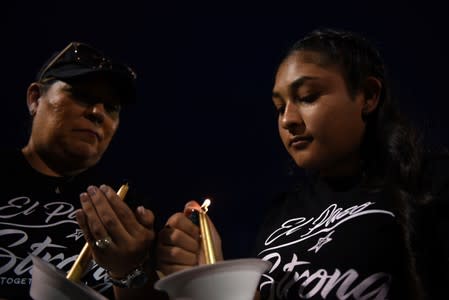 People gather for a vigil a day after a mass shooting in El Paso