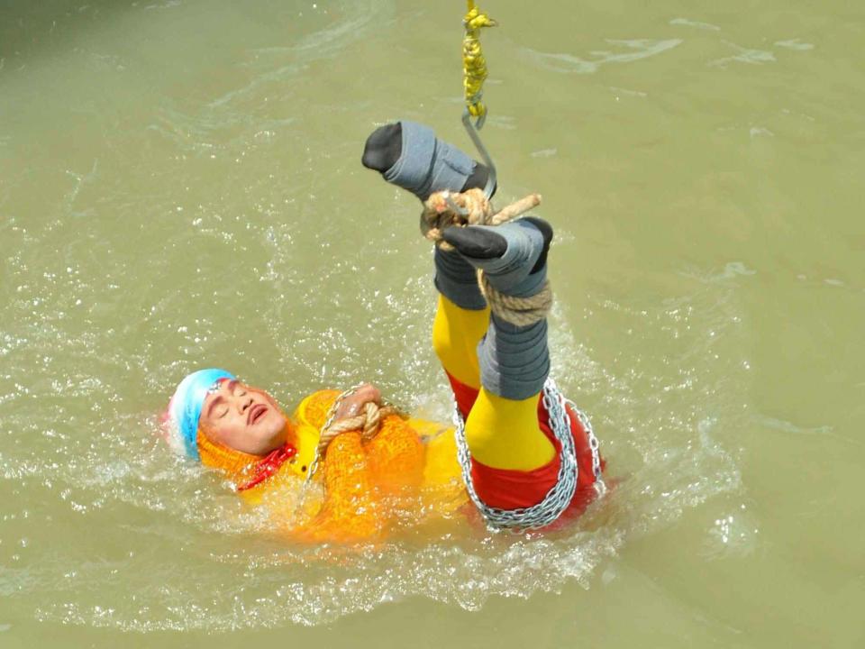 An Indian magician has drowned after being lowered into a river while shackled by a chain and six locks, police have confirmed.In the attempt to recreate a stunt made famous by Harry Houdini, Chanchal Lahiri, also known as Jadugar Mandrake, jumped blindfolded and with his limbs bound into the Hooghly river in Kolkata, West Bengal state.The 40-year-old was supposed to free himself and swim to safety, but never emerged from the water.His body washed up about 1km from the site of the stunt and was identified later on Monday, according to the BBC. Before attempting the trick, he reportedly told local photographer Jayant Shaw: “If I can free myself it will be magic, if I cannot it will be tragic.”Spectators who had gathered to watch his performance waited in vain, then became worried.“When he did not come out for a long time, people panicked,” Indian police told The Times of India. “A couple of people said they saw a man struggling, seeking help, in the middle of the river.”It is not the first time he has attempted an underwater escape, having in 2013 lowered himself 30ft into a river while caged.When he emerged after only six seconds, however, onlookers claimed they were cheated because the cage had a very visible false door, according to local reports.Twenty years ago, Mr Lahiri was lowered into Hooghly river in a glass box and managed to escape to safety.Mr Shaw, the photographer, said he also witnessed that trick.“I never thought he would not come out of the water this time,” he said.