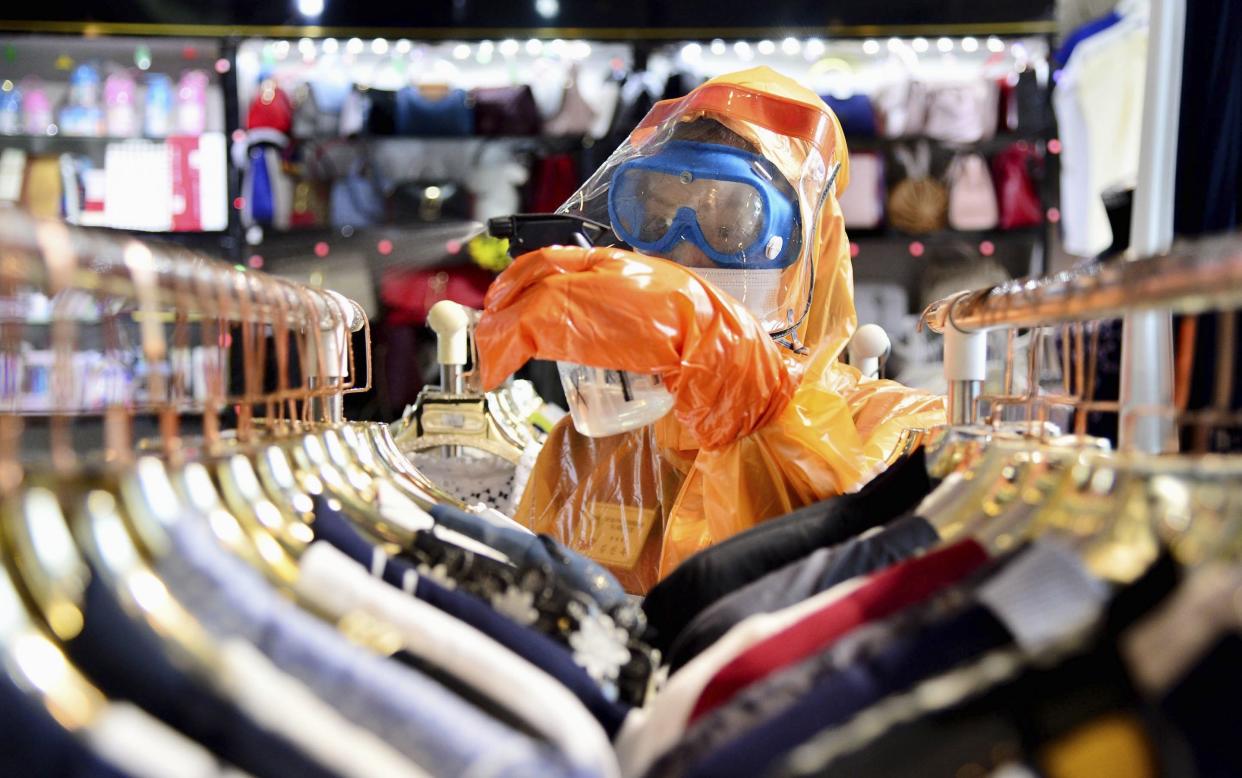 A worker in a protective suit disinfects a store in Pyongyang this week, amid fears over the spread of coronavirus - Kyodo/Newscom/Avalon