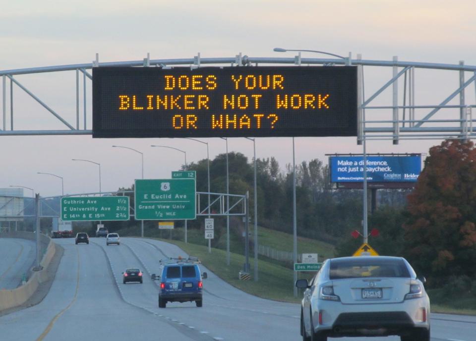 Iowa Department of Transportation roadside safety sign saying "Does your blinker not work or what?"