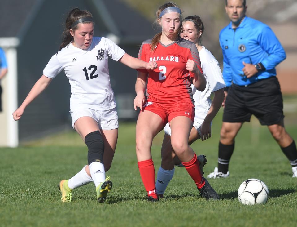 ADM's Helen Kirk kicks the ball to the goal around Lily Beall during the second half at Ballard's soccer field Tuesday, May 11, 2021, in Huxley, Iowa.