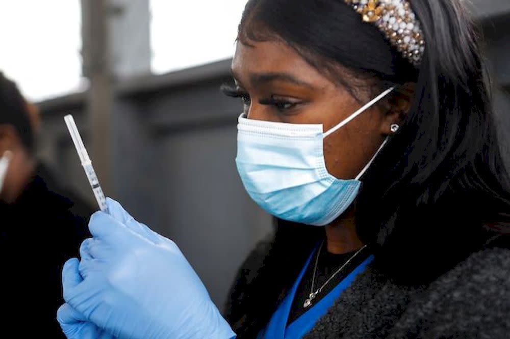 A medical worker prepares to administer the Pfizer-BioNTech Covid-19 vaccine at a drive-through Covid-19 vaccination site at the Strawberry Festival Fairgrounds in Plant City January 13, 2021. — Reuters pic