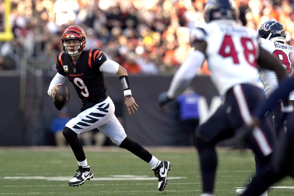 Cincinnati Bengals quarterback Joe Burrow (9) rolls out of the pocket against the Houston Texans during the second half of an NFL football game Sunday, Nov. 12, 2023, in Cincinnati. (AP Photo/Carolyn Kaster)