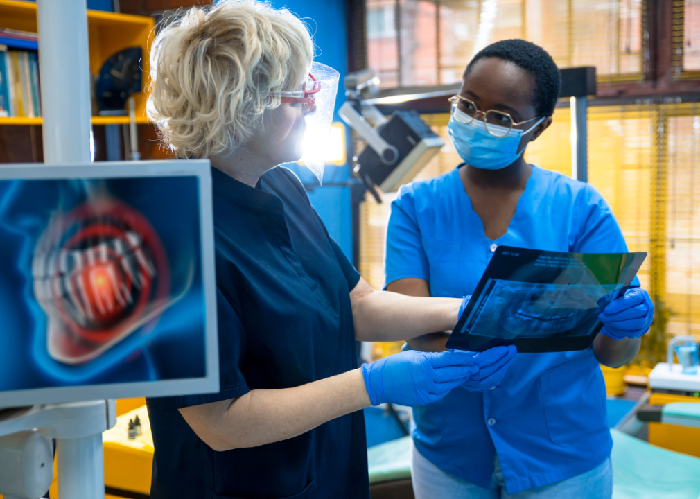 Two female health care professionals looking at X-rays. 