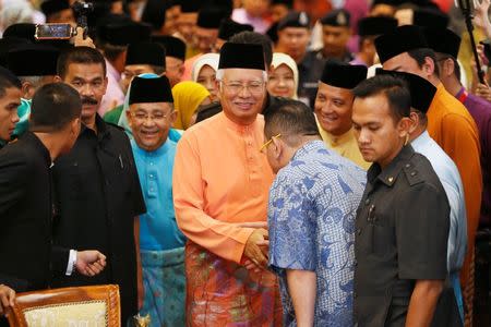 Malaysia's Prime Minister Najib Razak (C) smiles as he arrives at an event in Kuala Lumpur July 21, 2016. REUTERS/Lai Seng Sin