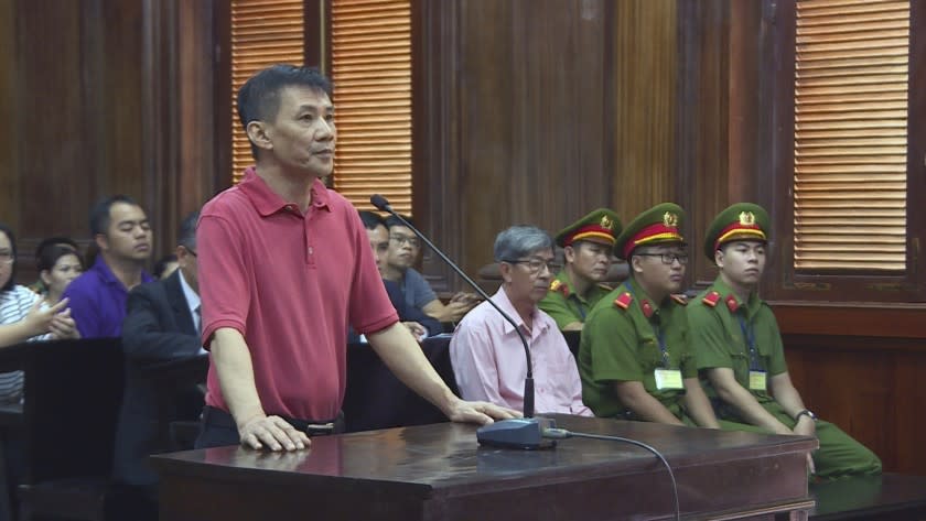 Michael Nguyen stands during his trial, Monday, June 24, 2019, in Ho Chin Minh City, Vietnam. The American of Vietnamese origin was sentenced to 12 years in prison for "attempt to overthrow the state." (Nguyen Thanh Chung/Vietnam News Agency via AP)