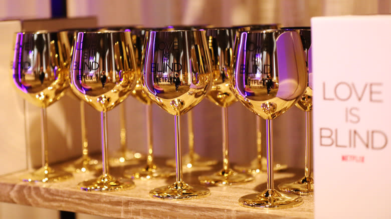 'Love Is Blind' branded gold metallic wine glasses