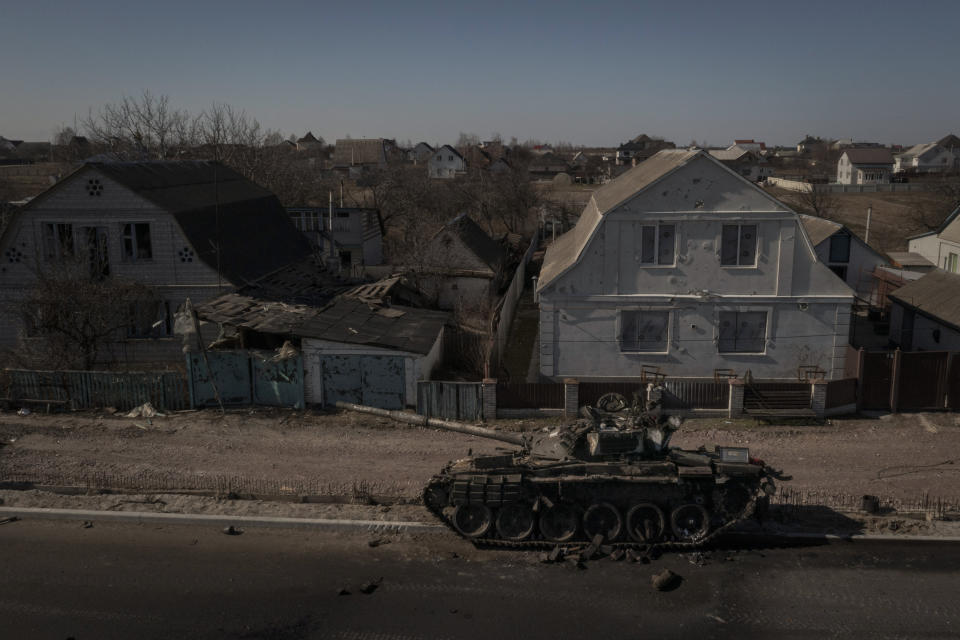 FILE - A destroyed tank is seen after battles between Ukrainian and Russian forces on a main road near Brovary, north of Kyiv, Ukraine, Thursday, March 10, 2022. Quantifying the toll of Russia’s war in Ukraine remains an elusive goal a year into the conflict. Estimates of the casualties, refugees and economic fallout from the war produce an complete picture of the deaths and suffering. Precise figures may never emerge for some of the categories international organizations are attempting to track. (AP Photo/Felipe Dana, File)