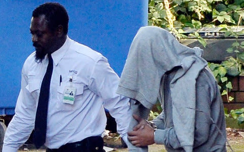 Ouissem Medouni (right), 40, who has been charged with the murder of French au pair Sabrina Kouider leaves Wimbledon Magistrates Court after being remanded on bail - Credit: David Dyson