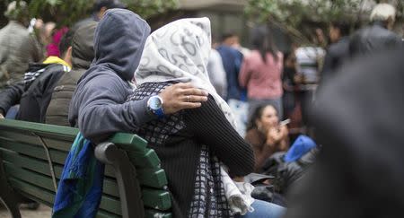 Migrants wait in front of the State Office for Health and Social Affairs (LaGeSo), in Berlin, Germany, September 3, 2015. REUTERS/Hannibal Hanschke