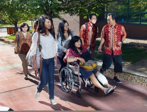 Rita Paulina, who was wounded during the shooting at the screening of "The Dark Knight Rises," arrives in a wheelchair with her family at the Arapahoe County Courthouse