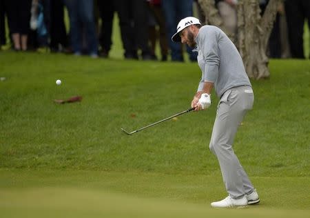 February 19, 2017; Pacific Palisades, CA, USA; Dustin Johnson hits onto the tenth hole green during the continuation of third round play in the Genesis Open golf tournament at Riviera Country Club. Mandatory Credit: Gary A. Vasquez-USA TODAY Sports
