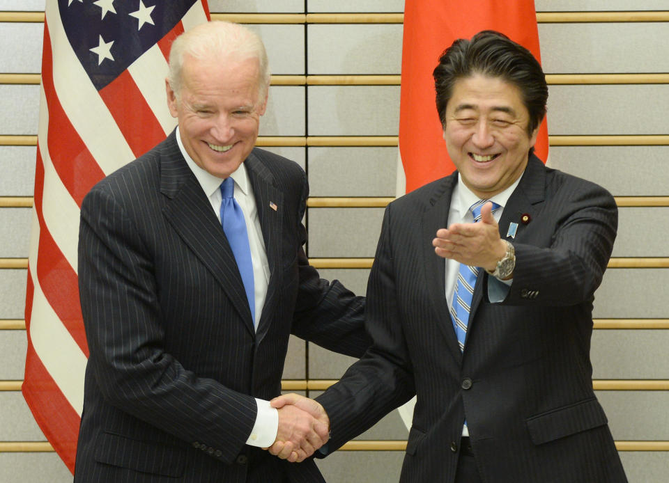 U.S. Vice President Joe Biden is welcomed by Japanese Prime Minister Shinzo Abe prior to their talks at Abe's official residence in Tokyo on December 3, 2013.  / Credit: TORU YAMANAKA/AFP via Getty Images