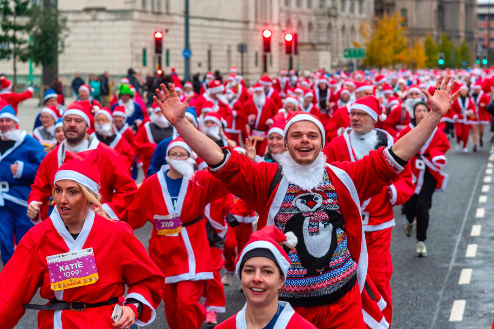 LIVERPOOL, UNITED KINGDOM - 2022/12/04: Runners race during the annual Liverpool Santa Dash. Thousands of runners take to the streets of Liverpool dressed as Father Christmas (Santa Claus) in red and blue suits during the BTR Liverpool Santa Dash 2022. This is a 5-kilometer fundraising run activity for charities, including the Alder Hey Children's Hospital. (Photo by Dave Rushen/SOPA Images/LightRocket via Getty Images)