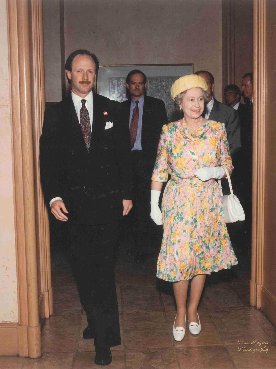 Queen Elizabeth II with Four Seasons Hotel Austin General Manager Tom Kelly in 1991.