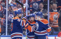 Edmonton Oilers' Leon Draisaitl (29), Ryan Nugent-Hopkins (93) and Zach Hyman (18) celebrate a goal against the Los Angeles Kings during the second period in Game 5 of an NHL hockey Stanley Cup first-round playoff series, on Wednesday May 1, 2024, in Edmonton, Alberta. (Jason Franson/The Canadian Press via AP)