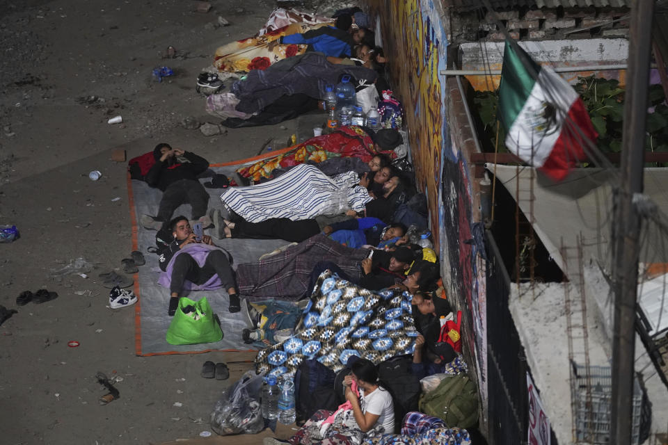 Migrants sleep outside a train station as they wait for the arrival of a northbound freight train, in Irapuato, Mexico, Saturday, Sept. 23, 2023. (AP Photo/Marco Ugarte)