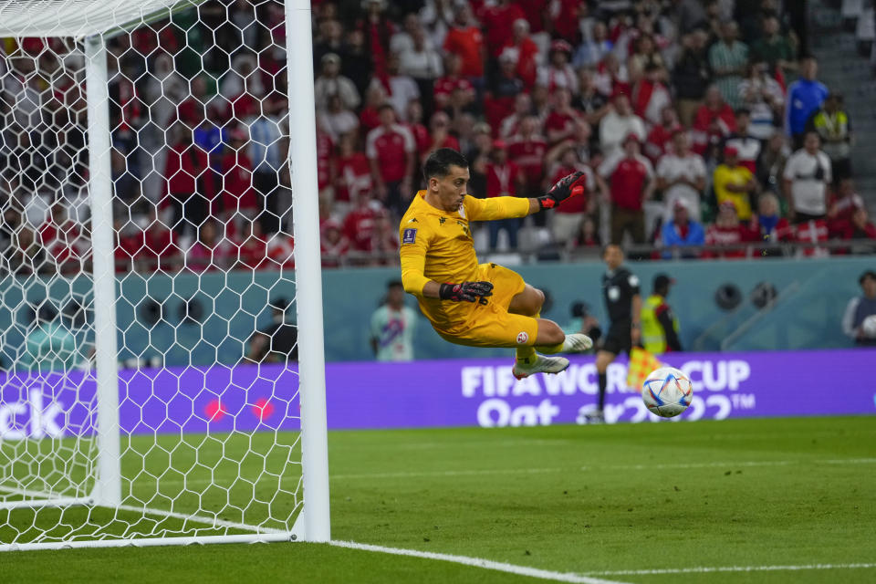 Tunisia's goalkeeper Aymen Dahmen makes a save during the World Cup group D soccer match between Denmark and Tunisia, at the Education City Stadium in Al Rayyan, Qatar, Tuesday, Nov. 22, 2022. The match ended in a 0-0 draw. (AP Photo/Manu Fernandez)