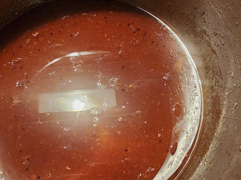 Barbecue sauce in a pot on a stovetop.