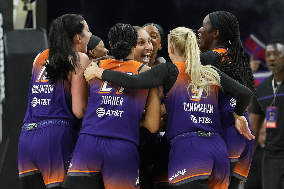 Phoenix Mercury Diana Taurasi, center, celebrates after making her 10,000th career point during the second half of a WNBA basketball game against the Atlanta Dream, Thursday, Aug. 3, 2023, in Phoenix. Taurasi, the WNBA's all-time leading scorer, is the only player in league history to reach the 10,000 point milestone. (AP Photo/Matt York)