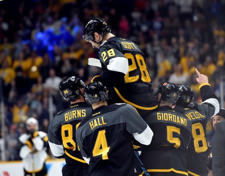 Jan 31, 2016; Nashville, TN, USA; Pacific Division forward John Scott (28) of the Montreal Canadiens is picked up by his teammates after beating the Atlantic Division during the championship game of the 2016 NHL All Star Game at Bridgestone Arena. Mandatory Credit: Christopher Hanewinckel-USA TODAY Sports