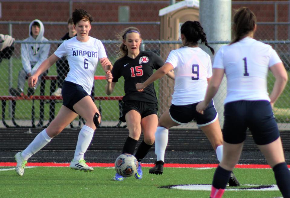 New Boston Huron's Rylie Cassette fights through the Airport defense during a game in 2022. Cassette rang up six goals and two assists in a Huron win Thursday.