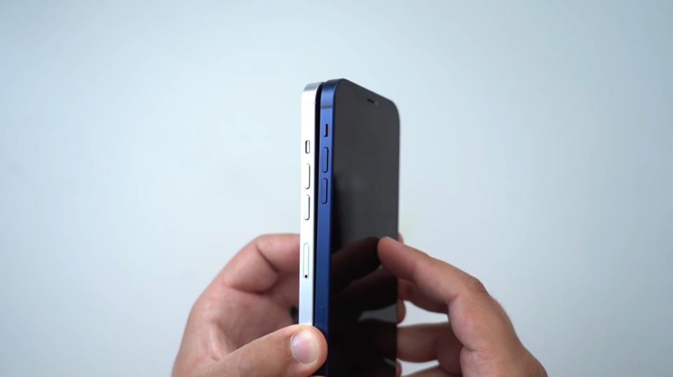 iPhone 13 dummy unit’s button placement (white) vs. iPhone 12 (blue). - Credit: MacRumors