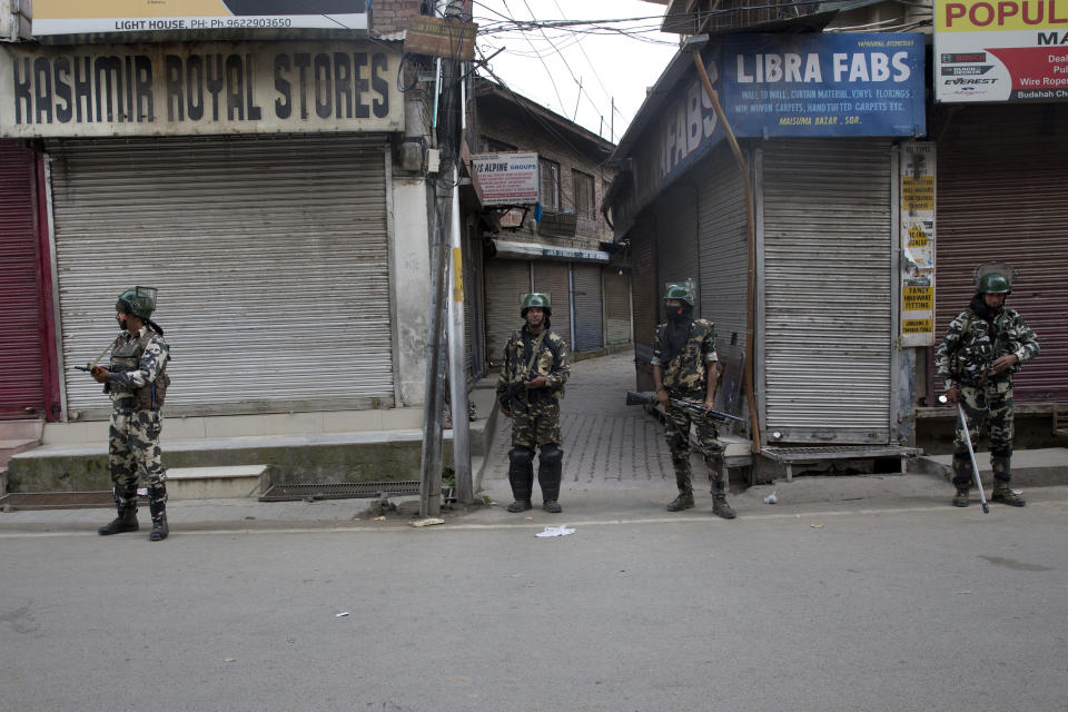 In this Tuesday, Aug. 6, 2019 photo, Indian paramilitary soldiers stand guard during curfew in Srinagar, Indian controlled Kashmir. The lives of millions in India's only Muslim-majority region have been upended since the latest — and most serious — crackdown followed a decision by New Delhi to revoke the special status of Jammu and Kashmir and downgrade the Himalayan region from statehood to a territory. Kashmir is claimed in full by both India and Pakistan, and rebels have been fighting Indian rule in the portion it administers for decades. (AP Photo/Dar Yasin)