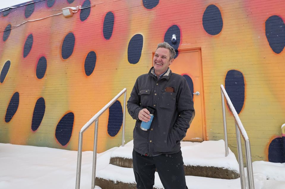Artist Chris Peterson stands near one of his murals at the Neighborhood Hive in Sugar House on Tuesday, April 4, 2023. Peterson is overseeing an art contest for the Utah Wildlife Federation. | Jeffrey D. Allred, Deseret News