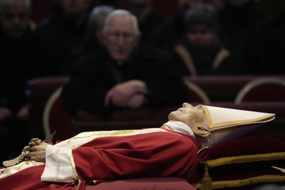 The body of late Pope Emeritus Benedict XVI is lied out in state inside St. Peter's Basilica at The Vatican, Wednesday, Jan. 4, 2023. Pope Benedict, the German theologian who will be remembered as the first pope in 600 years to resign, has died, the Vatican announced Saturday, Dec. 31, 2022. He was 95.(AP Photo/Ben Curtis)