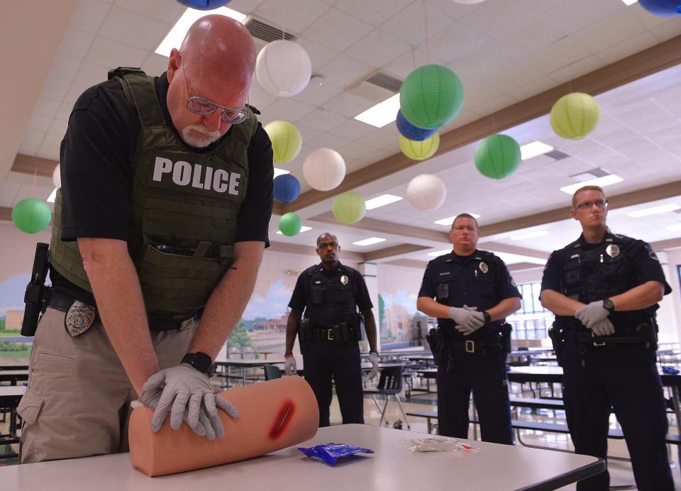 The Spartanburg Police Department holds active shooting training sessions at Pine Street Elementary School in Spartanburg, Thursday, July 14, 2022. Police officers, school personnel, and security officers take part in the  training, including first response medical triage. Investigator Michael Woodcock, left, participates in a training exercise to save lives from blood loss.