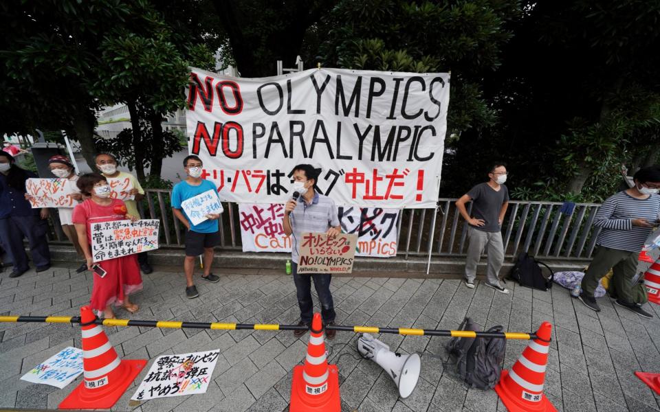 Protesters demonstrate against the Olympic and Paralympic Games, in front of the Prime Minister's Office, in Tokyo, Japan on 2 August 2021 - Kantaro Komiya/AP