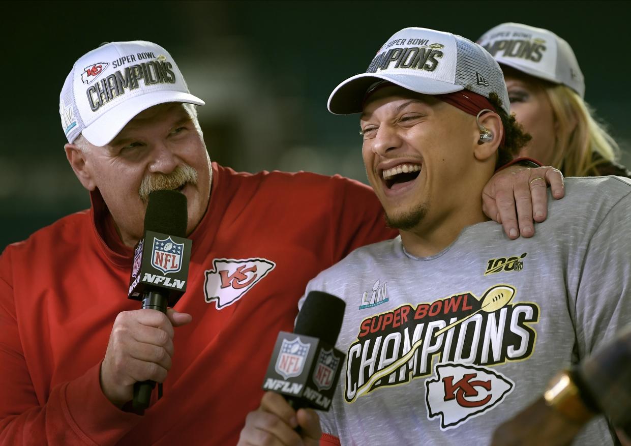 Andy Reid and Patrick Mahomes laugh while wearing Super Bowl champion gear after winning the Super Bowl.