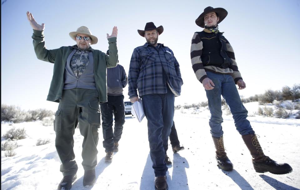 Men walk on a snow-covered road.