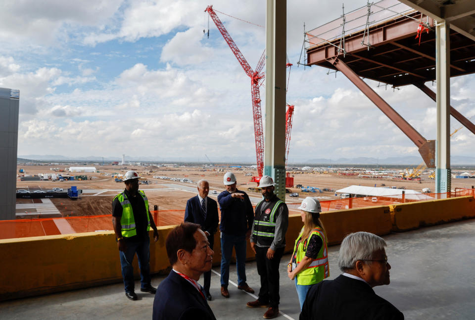 U.S. President Joe Biden talks to workers as CEO of TSMC C. C. Wei and Chairman of TSMC Mark Liu look on during a visit to TSMC AZ's first Fab (Semiconductor Fabrication Plant) in P1A (Phase 1A), in Phoenix, Arizona, U.S. December 6, 2022. REUTERS/Jonathan Ernst